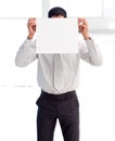 Businessman showing a white card covering his face Royalty Free Stock Photo