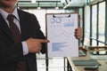 Businessman shows analytic financial accounting market chart and