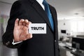 Businessman shows a business card with the word truth. Fact, honesty or ethical values