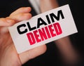 Businessman shows a card with text Claim Denied . Injury claim insurance concept