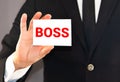 Businessman shows a card with word BOSS. CEO or general manager business concept