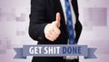 Businessman shows thumb up to `Get shit done!`