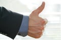 Businessman shows thumps up sign for his approval Royalty Free Stock Photo
