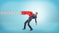 A businessman in side view gets hit with a large red boxing glove attached to a metal scissor arm on a blue background.