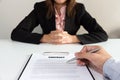 Businessman sign contract with businesswoman sitting at desk