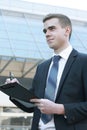 Businessman signing acceptance report contract, modern highrise