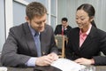 Businessman Signing Contract With Asian Businesswoman Royalty Free Stock Photo