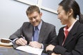 Businessman Signing Contract With Businesswoman Royalty Free Stock Photo