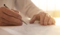 Businessman is signing a contract, close up of male hand putting signature Royalty Free Stock Photo