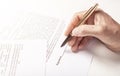 Businessman is signing a contract, close up of male hand putting signature Royalty Free Stock Photo
