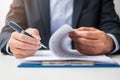 Businessman signing on contract documents after reading, man holding pen and approve on business report. Contract agreement, Royalty Free Stock Photo