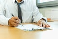 Businessman signing contract paper with pen in office desk. Royalty Free Stock Photo