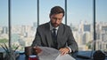 Businessman signing corporate papers in office. Successful bearded manager read Royalty Free Stock Photo