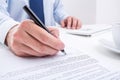 Businessman signing a document.