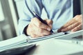 Businessman signing a document, taking notes, completing a questionnaire or writing correspondence. Close up view of man Royalty Free Stock Photo