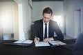 Businessman signing a document while working at his office desk Royalty Free Stock Photo