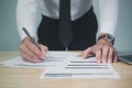 Businessman signing documents, analyzing data in office Royalty Free Stock Photo