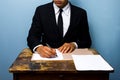 Businessman signing documents at wooden desk Royalty Free Stock Photo