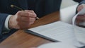 Businessman signing official documents close up. Man putting signature on papers Royalty Free Stock Photo