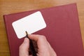 Businessman signs a business card