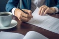 Businessman signs important legal documents on the desktop with Cup of coffee Royalty Free Stock Photo
