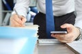 Businessman signs stack documents in table office