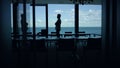 Businessman silhouette enjoying break in conference room. Manager going at pause