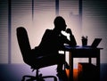 Businessman silhouette sitting in office and thinking, anonymous member of shadow government