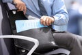Businessman siting on a chair and geting out documents with gr