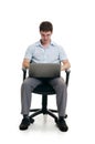 The businessman sits in an armchair with laptop Royalty Free Stock Photo