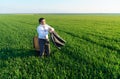 Businessman sits in an office chair in a field and rests, freelance and business concept, green grass and blue sky as background Royalty Free Stock Photo