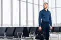 Businessman sitting at airport waiting lounge and waiting for flight. Male executive in airport business lounge sitting Royalty Free Stock Photo