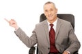 Businessman sitting on armchair and pointing Royalty Free Stock Photo