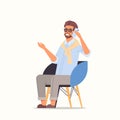 Businessman sitting on armchair using smartphone business man talking on cellphone communication Royalty Free Stock Photo