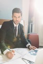 businessman sitting on bed with newspaper