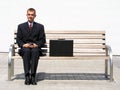 Businessman sitting on bench Royalty Free Stock Photo