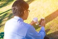 Businessman,He is sitting on bench in park.He is thinking about business. Royalty Free Stock Photo