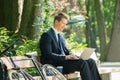 Businessman Sitting On Bench Using Laptop Royalty Free Stock Photo