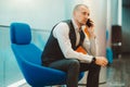 Businessman sitting in blue armchair Royalty Free Stock Photo