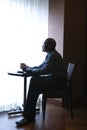 Businessman Sitting by Cafe Window Royalty Free Stock Photo