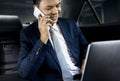 Businessman sitting in the car talking on phone Royalty Free Stock Photo