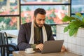 Businessman sitting in coffee shop working with laptop computer Royalty Free Stock Photo