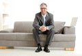 Businessman sitting on couch Royalty Free Stock Photo