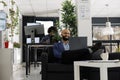 Businessman sitting on couch while having videocall with client Royalty Free Stock Photo