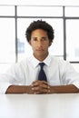 Businessman Sitting At Desk In Office Thinking