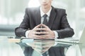 Young aspiring businessman sitting at a Desk before an open laptop