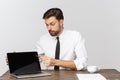 Businessman sitting at desk point finger at isolated white laptop screen with empty copy space, handsome young business Royalty Free Stock Photo