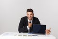 Businessman sitting at desk point finger at isolated white laptop screen with empty copy space, handsome young business Royalty Free Stock Photo