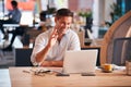 Businessman Sitting At Desk On Video Call In Modern Open Plan Office Royalty Free Stock Photo