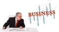 Businessman sitting at desk with word cloud Royalty Free Stock Photo